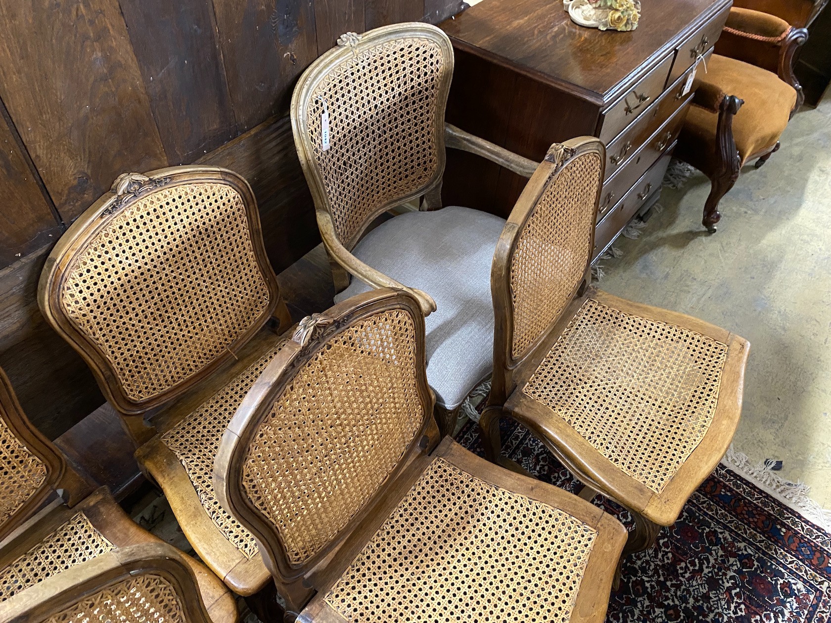 A set of six French carved beech dining chairs and a similar elbow chair